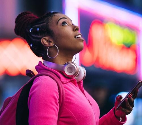 Woman using smart phone at night