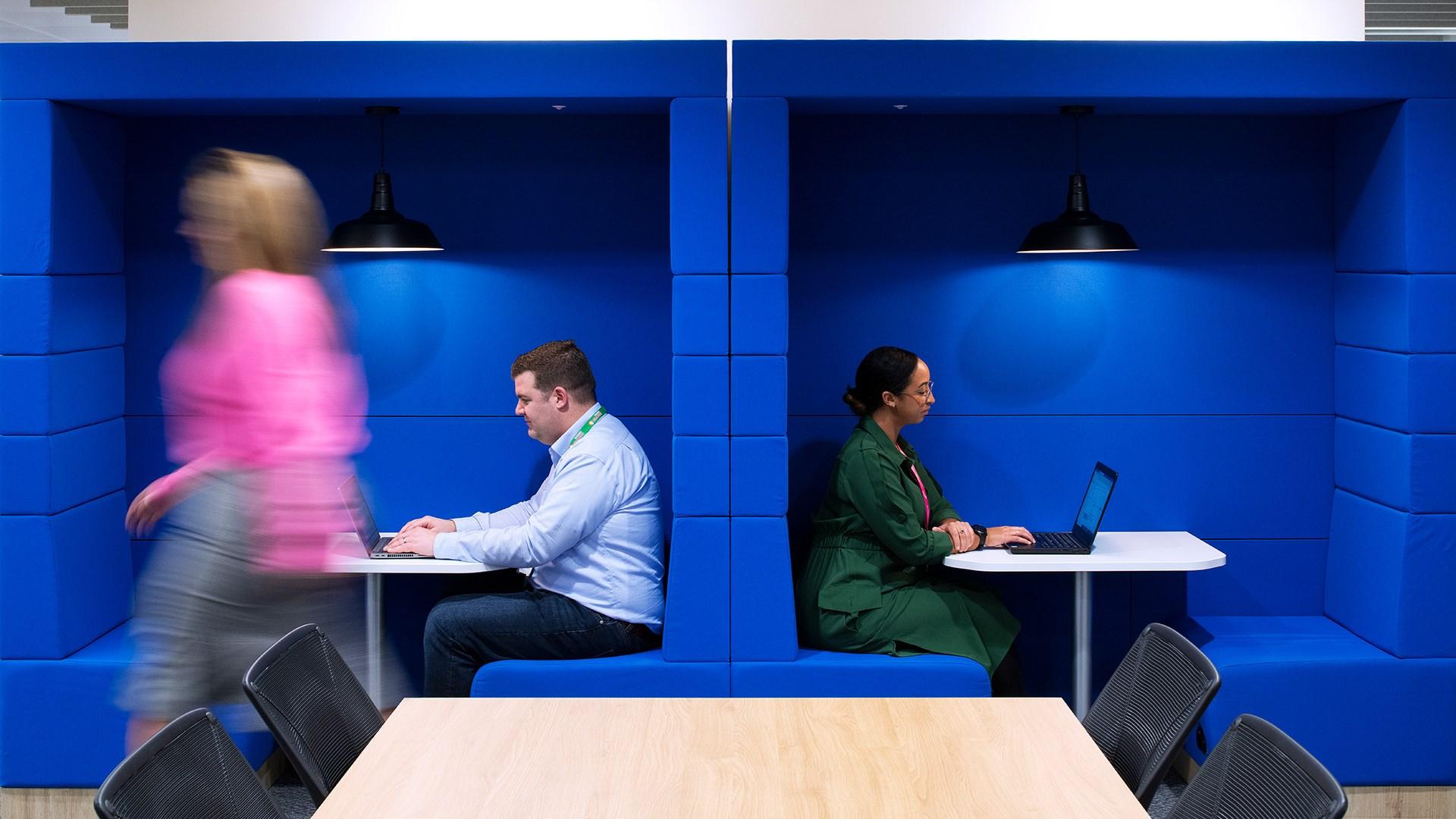 People working in an office space on laptops