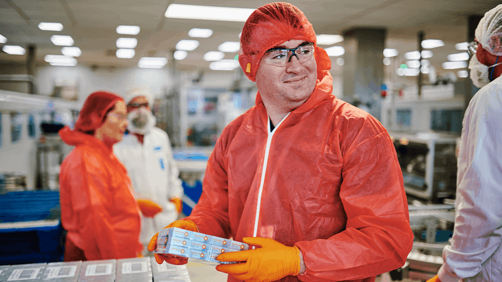 Factory worker holding Nurofen packaging