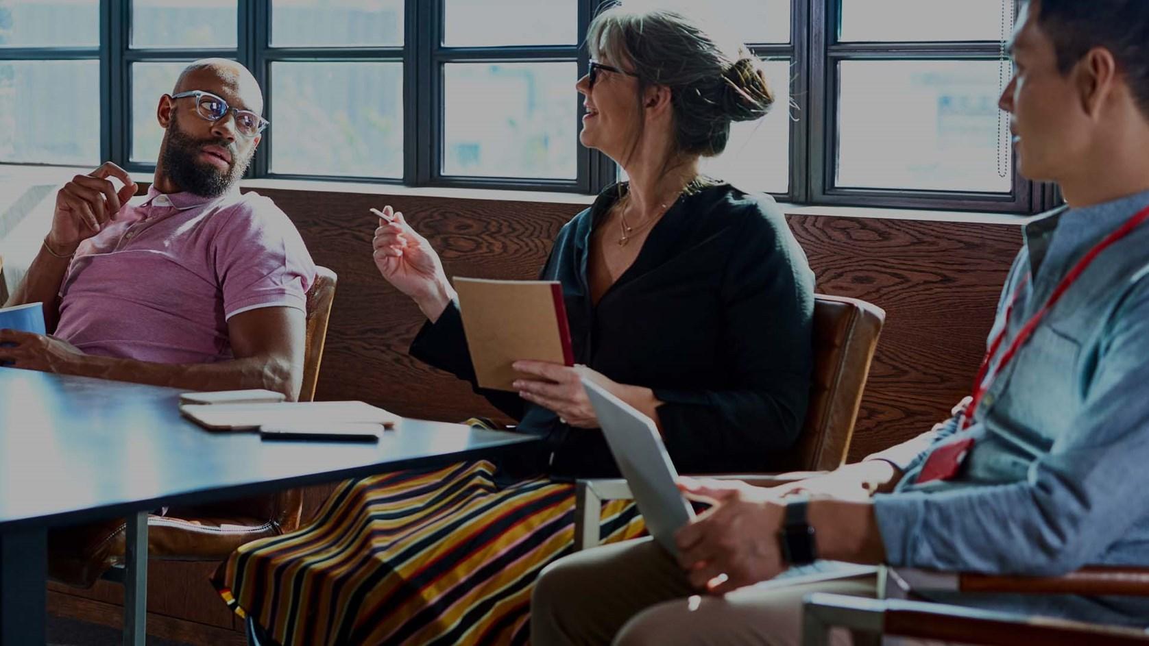 Mature woman leading a team meeting in the board room.